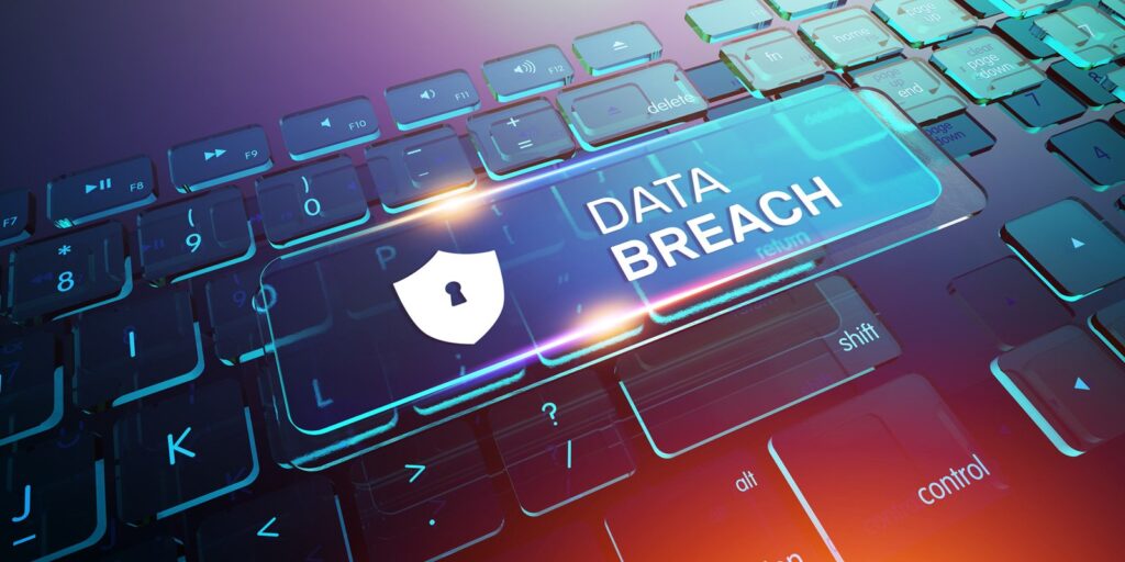 A button with the word "data breach" on it reflects the increasing cybersecurity threats, such as the recent Harvard Pilgrim Health Care ransomware attack affecting millions.